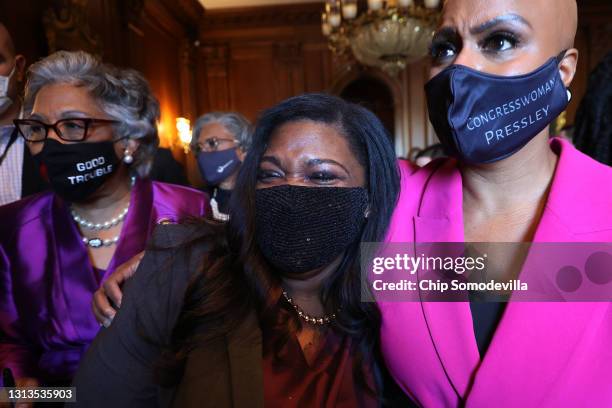 Rep. Cori Bush and Rep. Ayanna Pressley walk with their arms around each other as members of the Congressional Black Caucus walk to a news conference...