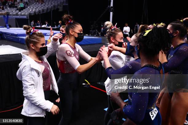 Carly Woodard of the Oklahoma Sooners congratulates the Michigan Wolverines during the Division I Women’s Gymnastics Championship held at Dickies...