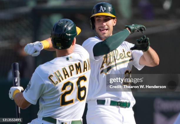 Matt Olson and Matt Chapman of the Oakland Athletics celebrates after Olson hit a grand slam home run against the Minnesota Twins in the fourth...