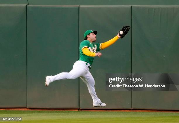 Ramon Laureano of the Oakland Athletics make a running catch taking a hit away from Mitch Garver of the Minnesota Twins in the fourth inning during...