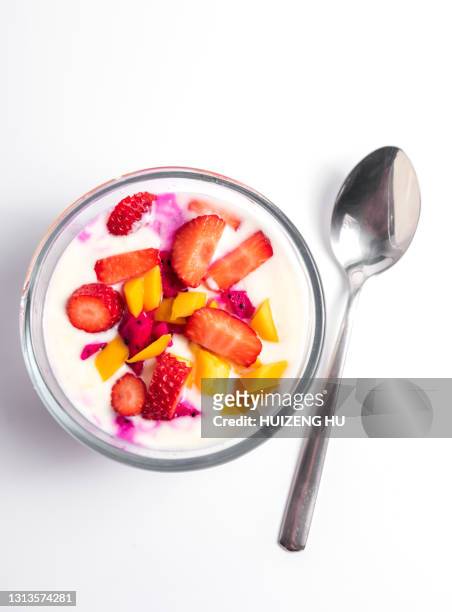 greek yogurt, bowl of fresh mixed berries and yogurt with fresh strawberries, mango and pitaya - greek yogurt stock pictures, royalty-free photos & images