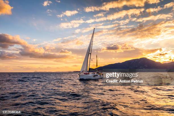 yacht with white sails on a background of sunset at sea. yacht adventure - air freight transportation stock pictures, royalty-free photos & images