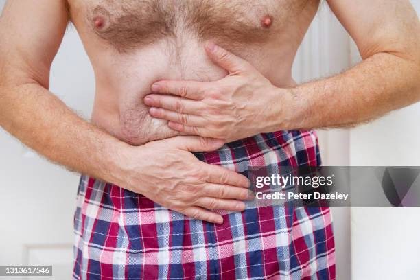 man in boxer shorts with pain in gut - ghiandola intestinale foto e immagini stock