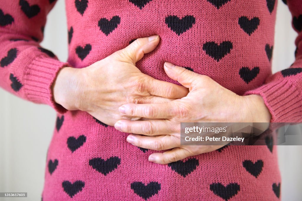 Woman with pain, massaging herself