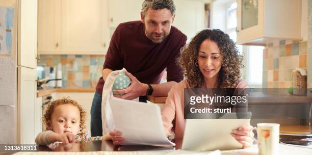 shopping around - young family in kitchen stock pictures, royalty-free photos & images