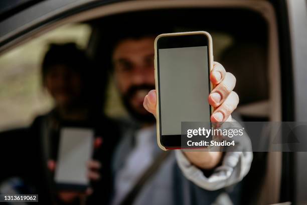 man and woman approaching mobile app - holding stock pictures, royalty-free photos & images