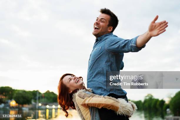 woman holding man in air, his arms outstretched - london 2018 day 2 bildbanksfoton och bilder