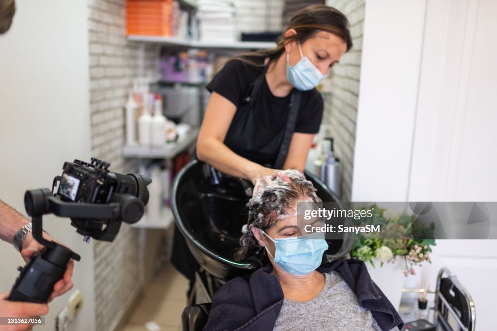Hair dresser working with a face mask during coronavirus pandemic