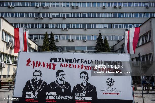 Car pushes couples up a banner with Polish Judges cartoons critical of the ongoing governmental Judicial reforms during a protest against an ongoing...