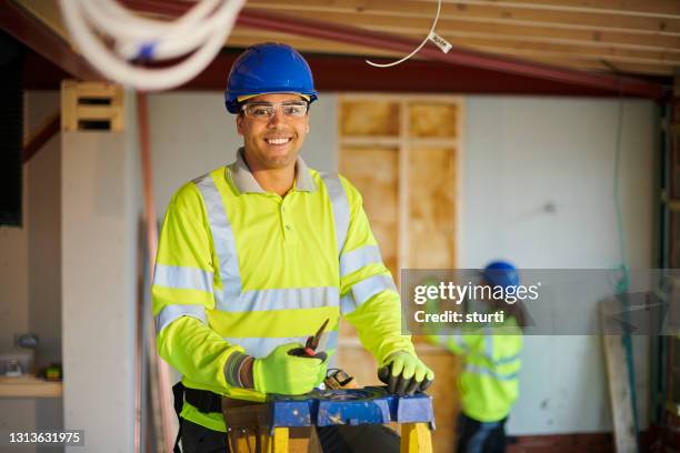 happy electrician on site - electrician stock pictures, royalty-free photos & images