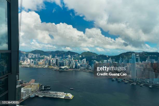 high angle view of hong kong skyline through a wondow - hong kong harbour stock pictures, royalty-free photos & images