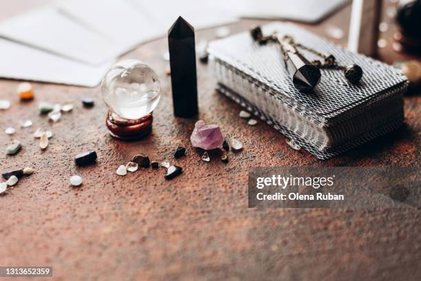 various gems and balls on a black bag with space - tarot cards stock-fotos und bilder