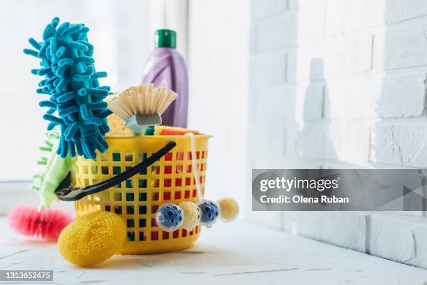 brushes, sponges, cleaning agent in a bucket with place for text on the wall - bucket stock-fotos und bilder