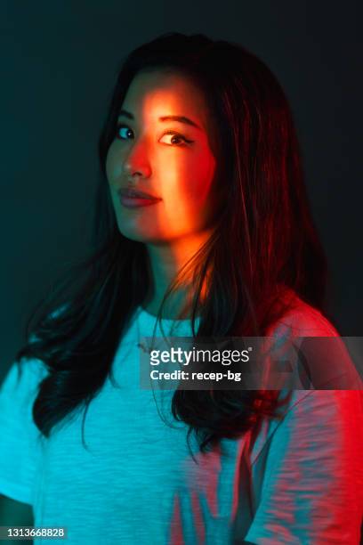 portrait of beautiful woman lit by neon colored lights - beauty laser stock pictures, royalty-free photos & images