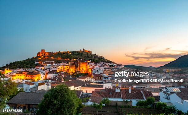 town view of the village aracena with illuminated fortress castillo de aracena, evening mood, aracena, huelva, spain - provincia de huelva stock pictures, royalty-free photos & images