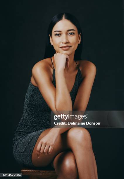 shot of a beautiful young woman sitting against a black background - beauty portrait studio shot stock pictures, royalty-free photos & images