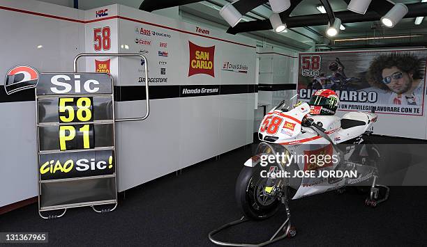 The helmet and the motorcycle of Italian MotoGP rider Marco Simoncelli are displayed as a tribute at Ricardo Tormo racetrack in Cheste near Valencia...