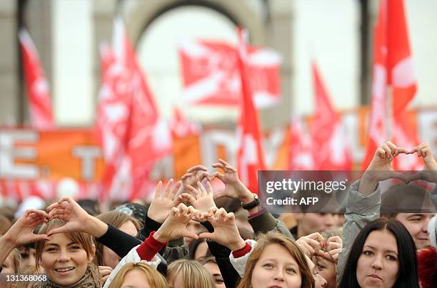 Activists of the pro-Kremlin youth movement "Nashi" carry their flags as they rally in front of the VVts All Russian Exhibition Centre, formerly...