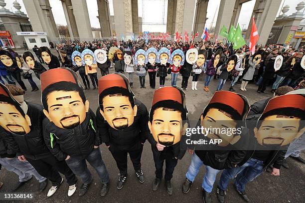 Wearing masks activists of the pro-Kremlin youth movement "Nashi" rally in front of the VVts All Russian Exhibition Centre, formerly known as VDNKh,...