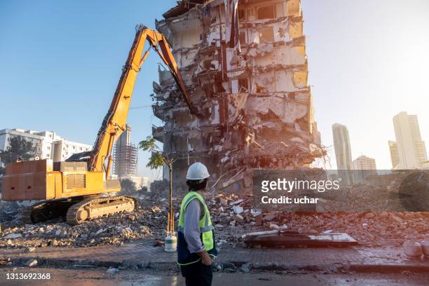 medical masked engineer engineer at building  construction site with machinery background - earthquake stock pictures, royalty-free photos & images