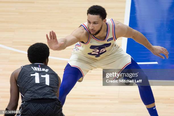 Ben Simmons of the Philadelphia 76ers guards Kyrie Irving of the Brooklyn Nets at the Wells Fargo Center on April 14, 2021 in Philadelphia,...