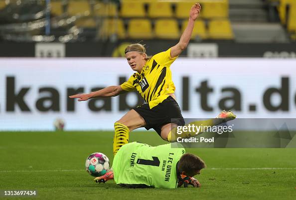Halanda Erling Haaland of Borussia Dortmund has a shot saved whilst under ...