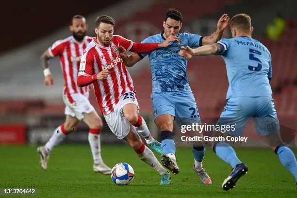 Nick Powell of Stoke City battles for possession with Matty James of Coventry City during the Sky Bet Championship match between Stoke City and...