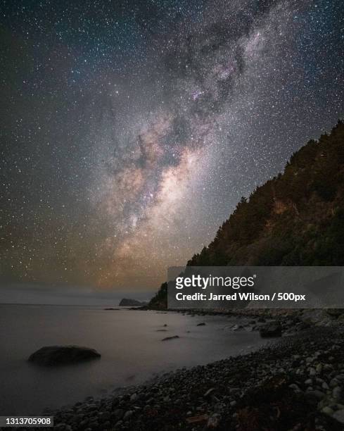 scenic view of sea against sky at night,pauanui,new zealand - timelapse new zealand stock pictures, royalty-free photos & images