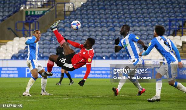 Daryl Dike of Barnsley scores the opening goal with an overhead kick during the Sky Bet Championship match between Huddersfield Town and Barnsley at...