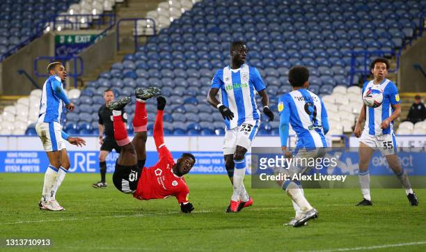 Daryl Dike of Barnsley scores the opening goal with an overhead kick during the Sky Bet Championship match between Huddersfield Town and Barnsley at...
