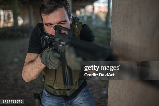 Professional Military Operator Aiming With Rifle In War Zone High-Res ...