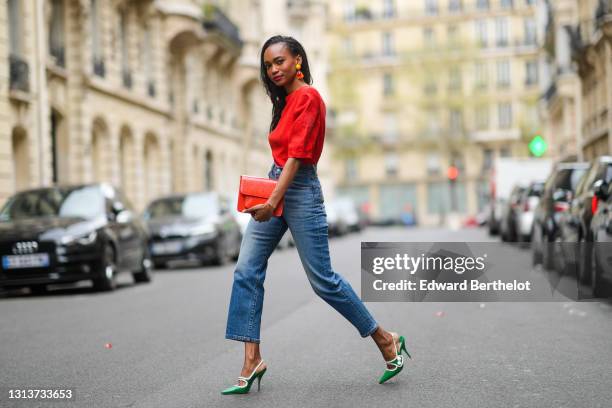 Emilie Joseph @in_fashionwetrust wears a red vintage linen power shoulder top worn backwards with plunging neckline in the back, blue denim high rise...