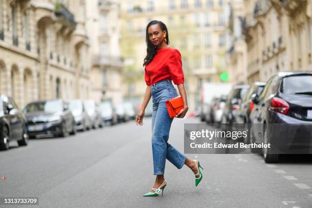 Emilie Joseph @in_fashionwetrust wears a red vintage linen power shoulder top worn backwards with plunging neckline in the back, blue denim high rise...