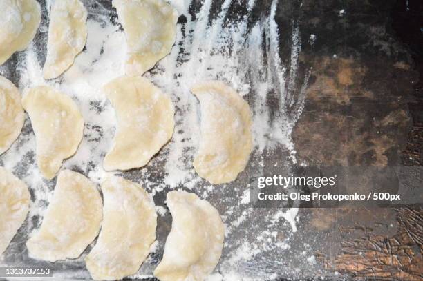 high angle view of dough on table - oleg prokopenko stock-fotos und bilder