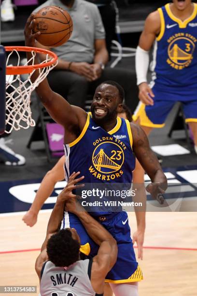 Draymond Green of the Golden State Warriors goes up for a shot over Ish Smith of the Washington Wizards during the second half at Capital One Arena...