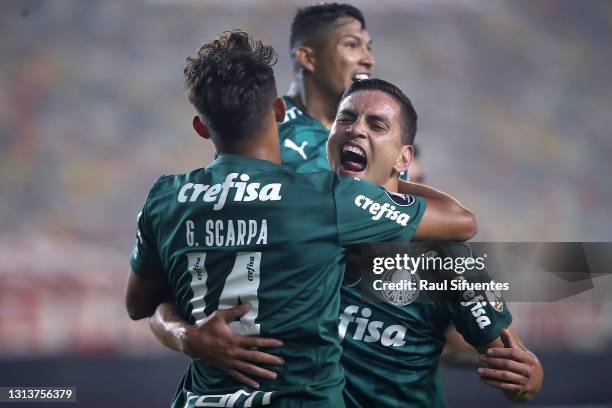 Renan of Palmeiras celebrates with teammate Gustavo Scarpa after scoring the third goal of his team during a match between Universitario and...