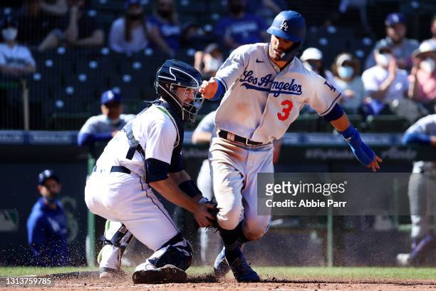 Chris Taylor of the Los Angeles Dodgers is tagged out at home plate by Tom Murphy of the Seattle Mariners during the ninth inning at T-Mobile Park on...