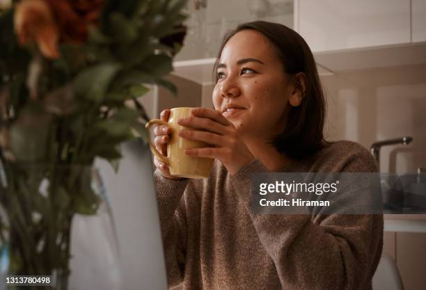 cropped shot of an attractive young woman sitting and working from home while enjoying a cup of coffee - connected mindfulness work stock pictures, royalty-free photos & images