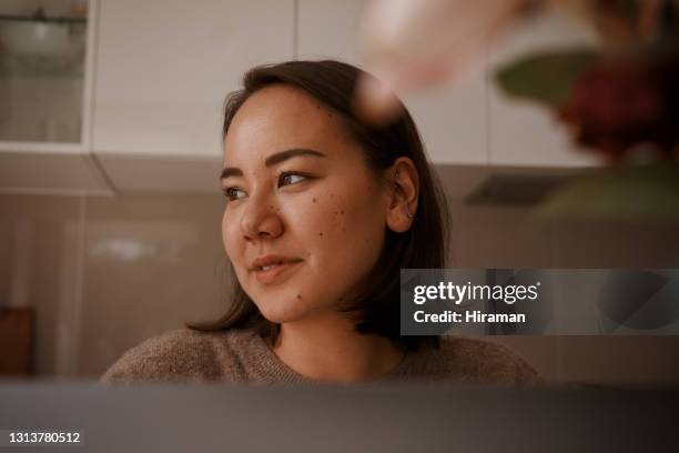 cropped shot of an attractive young woman sitting alone and working from home on her laptop during the day - connected mindfulness work stock pictures, royalty-free photos & images