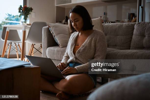 cropped shot of an attractive young woman sitting alone and working from home on her laptop during the day - part time worker stock pictures, royalty-free photos & images