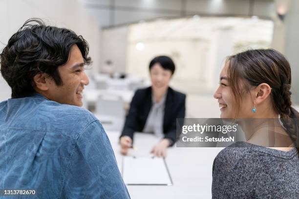 asian married couple consulting with agent - lawyer explaining stock pictures, royalty-free photos & images