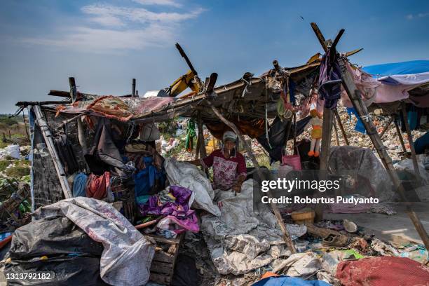 Scavenger sorts out plastic bottles at Jabon landfill on April 22, 2021 in Sidoarjo, East Java, Indonesia. The Indonesian Government has through the...