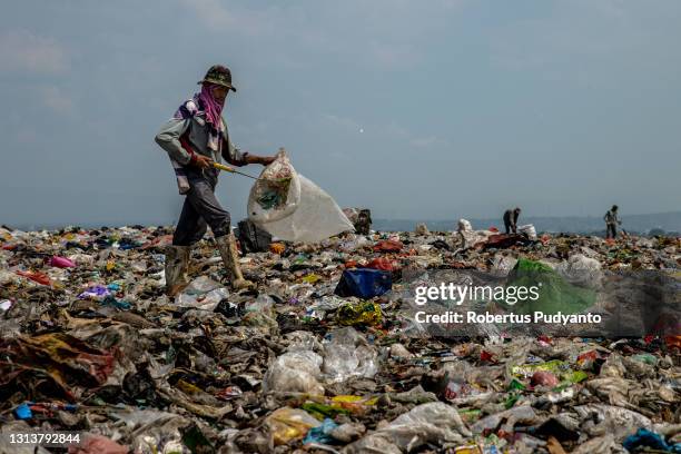 Scavenger looks for plastic bottles at Jabon landfill on April 22, 2021 in Sidoarjo, East Java, Indonesia. The Indonesian Government has through the...