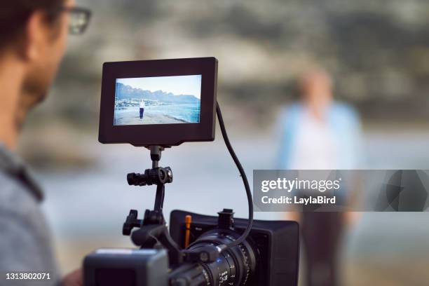 cropped shot of an unrecognizable man filming outside on his set - montagem de filme estúdio de cinema imagens e fotografias de stock