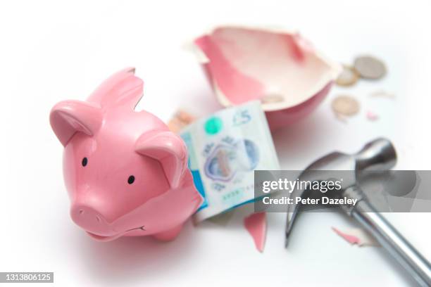 broken piggy bank with £5 pound notes - smashed piggy bank stock pictures, royalty-free photos & images