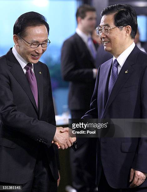 Lee Myung-bak, South Korea's president shakes hands with Hu Jintao, China's president ahead of a working session on the second day of the G20 Summit...