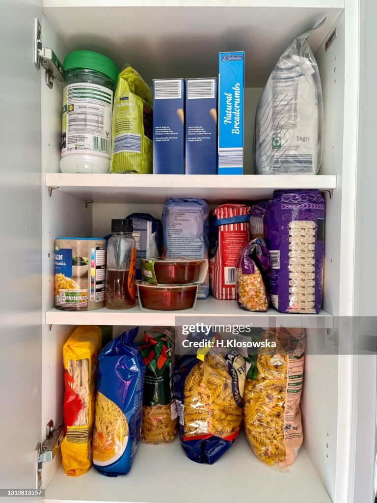 Kitchen cabinet stocked with dry food