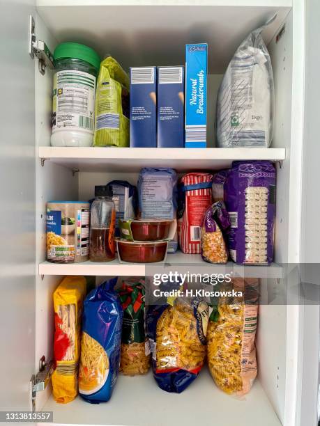 kitchen cabinet stocked with dry food - pantry shelf stock pictures, royalty-free photos & images