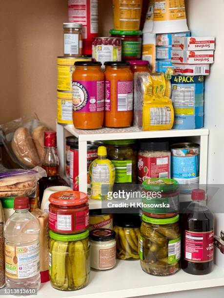 kitchen pantry stocked up with tinned food and pickles - food staple stock pictures, royalty-free photos & images