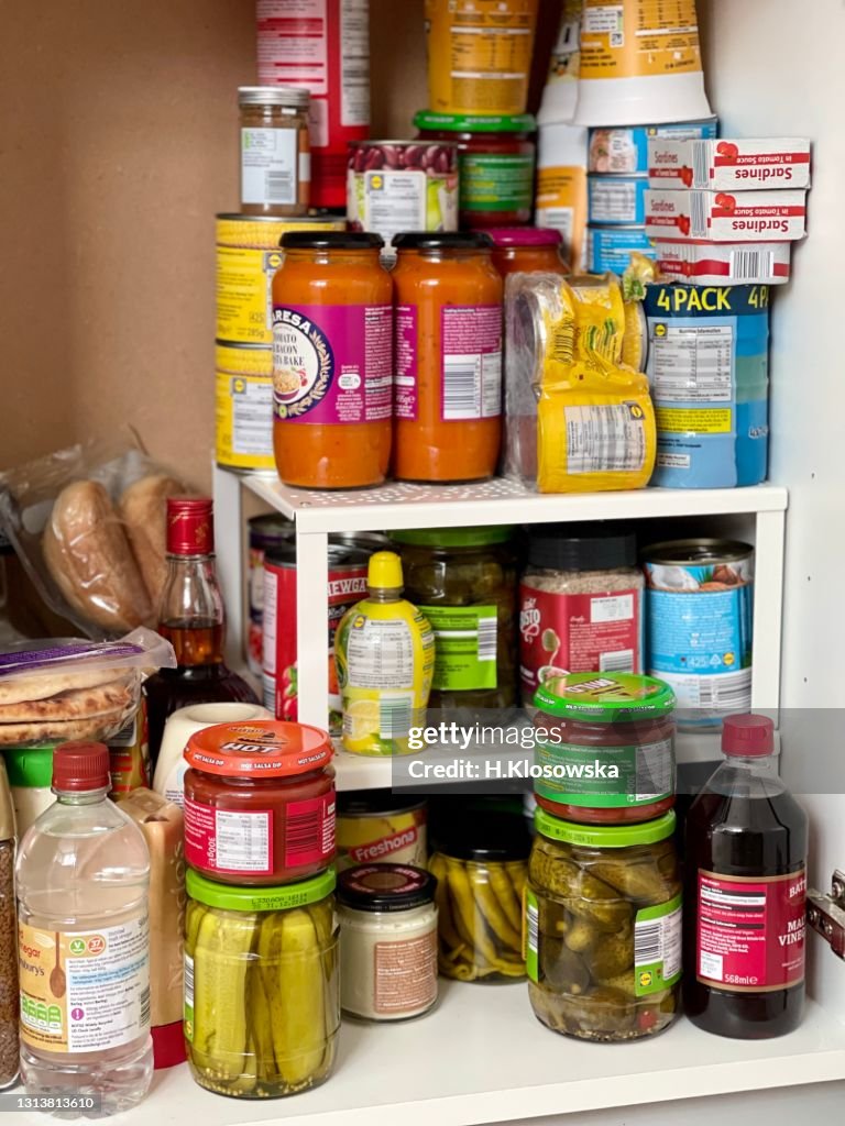 Kitchen pantry stocked up with tinned food and pickles